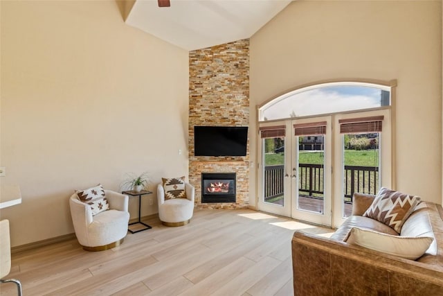 620 Parkview Dr Unit 61, Steamboat Springs, CO 80487 - living room with wood finished floors, french doors, high vaulted ceiling, a fireplace, and ceiling fan