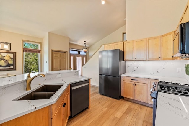 620 Parkview Dr Unit 61, Steamboat Springs, CO 80487 - kitchen with freestanding refrigerator, dishwasher, gas range oven, light wood finished floors, and a sink