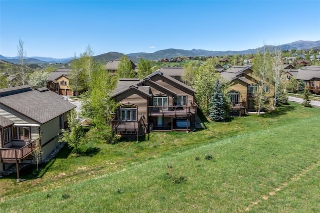 620 Parkview Dr Unit 61, Steamboat Springs, CO 80487 - view of front of property with a residential view, a deck with mountain view, and a front lawn