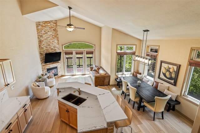 620 Parkview Dr Unit 61, Steamboat Springs, CO 80487 - living area featuring lofted ceiling, light wood-style floors, a ceiling fan, and healthy amount of natural light