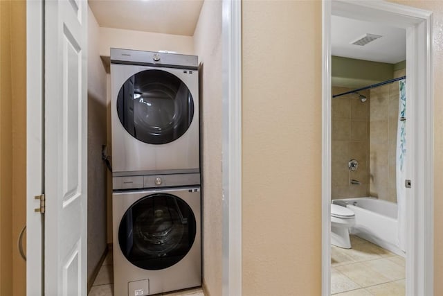 620 Parkview Dr Unit 61, Steamboat Springs, CO 80487 - laundry room with stacked washer / drying machine and tile patterned floors