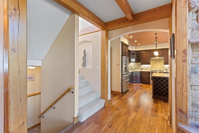 66 Chaparral Ln, Breckenridge, CO 80424 - hall with light wood-type flooring, arched walkways, beam ceiling, and stairs