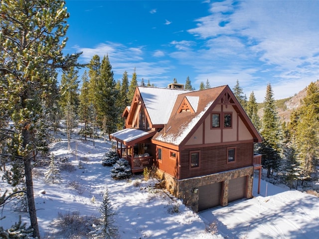 66 Chaparral Ln, Breckenridge, CO 80424 - view of snowy exterior featuring stone siding, a garage, and a deck