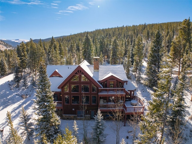66 Chaparral Ln, Breckenridge, CO 80424 - view of snowy exterior featuring stone siding, an attached garage, and a wooden deck