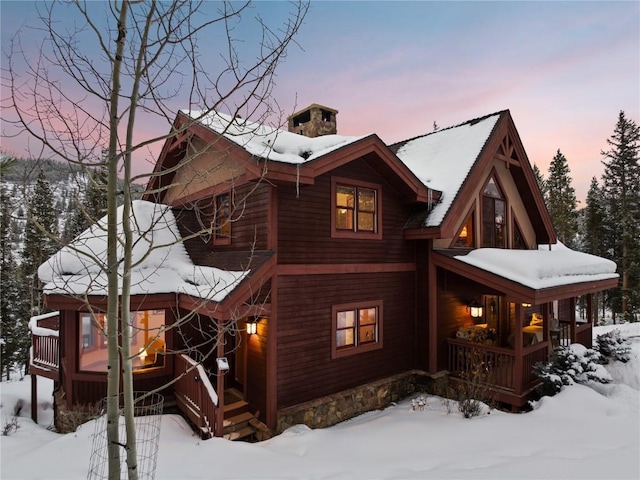 66 Chaparral Ln, Breckenridge, CO 80424 - view of front of home featuring covered porch and a chimney