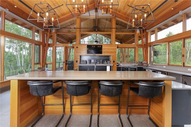 22 Vernon Way, Silverthorne, CO 80498 - kitchen featuring wooden ceiling, a chandelier, high vaulted ceiling, light countertops, and a spacious island
