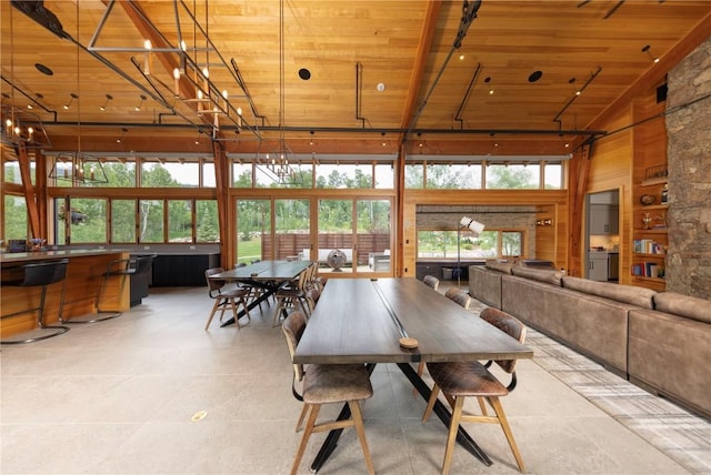 22 Vernon Way, Silverthorne, CO 80498 - dining room featuring wood ceiling, high vaulted ceiling, wood walls, and light tile patterned flooring