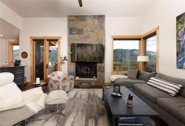 22 Vernon Way, Silverthorne, CO 80498 - living area featuring wood finished floors, a stone fireplace, and a mountain view
