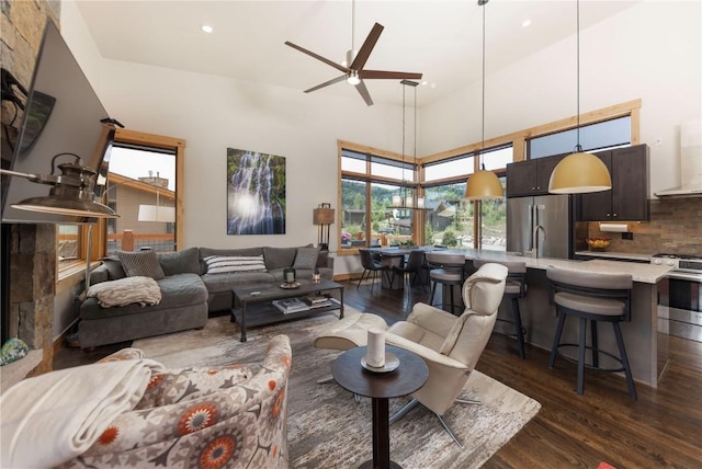 22 Vernon Way, Silverthorne, CO 80498 - living room featuring dark wood-style floors, a ceiling fan, recessed lighting, and a towering ceiling