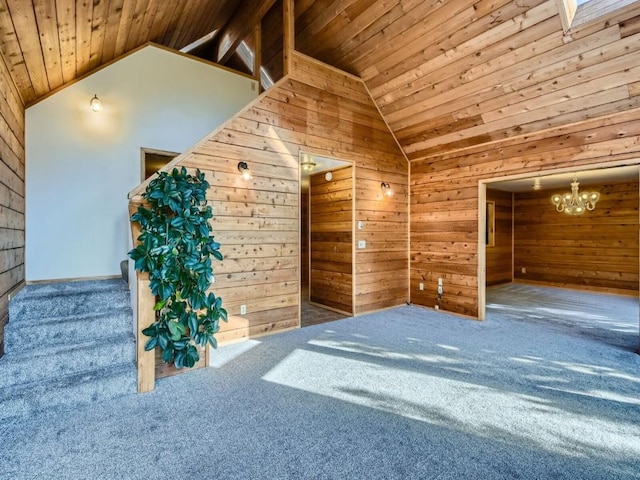 134 Hideaway Ct, Dillon, CO 80435 - unfurnished living room with wooden ceiling, wooden walls, lofted ceiling, carpet, and a chandelier