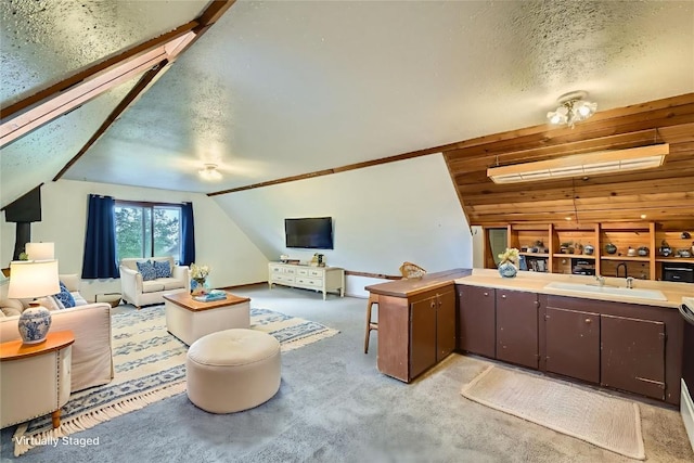 134 Hideaway Ct, Dillon, CO 80435 - living area with lofted ceiling, light carpet, and a textured ceiling