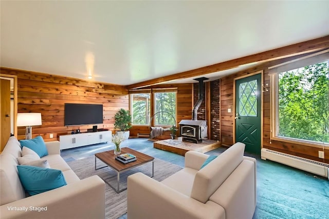 134 Hideaway Ct, Dillon, CO 80435 - living area featuring wood walls, a wood stove, a baseboard radiator, and carpet floors