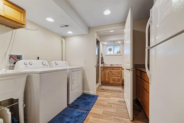726 Cumberland Dr, Jefferson, CO 80456 - clothes washing area with washing machine and clothes dryer, light wood-style floors, laundry area, visible vents, and recessed lighting