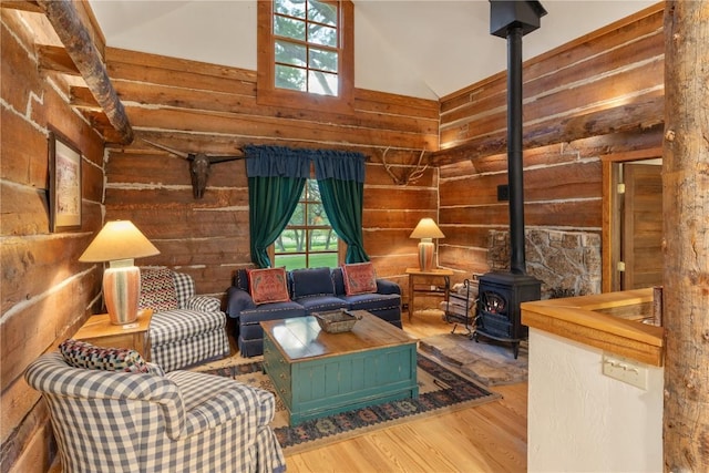 34074 Fruitland Mesa Rd, Crawford, CO 81415 - living area with wooden walls, wood finished floors, high vaulted ceiling, and a wood stove