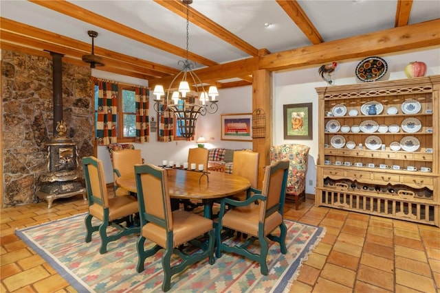 34074 Fruitland Mesa Rd, Crawford, CO 81415 - dining area featuring beamed ceiling, a chandelier, and a wood stove