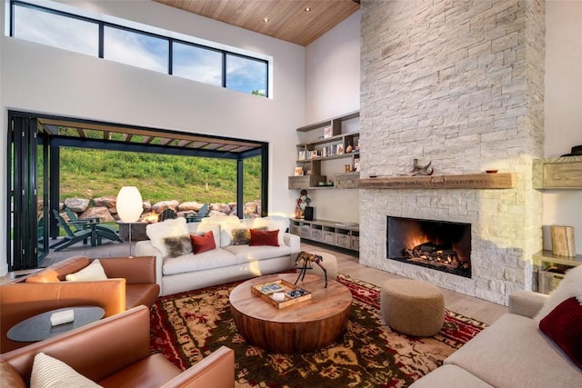 33200 Meadow Creek Dr, Steamboat Springs, CO 80487 - living room with a towering ceiling, wood finished floors, a stone fireplace, and wooden ceiling
