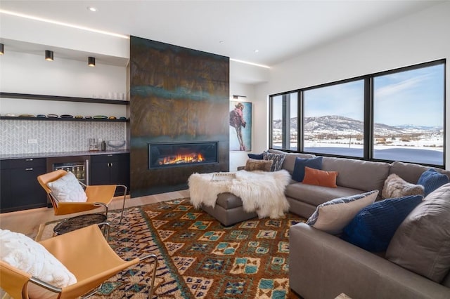33200 Meadow Creek Dr, Steamboat Springs, CO 80487 - living area with a mountain view, a fireplace, recessed lighting, and bar area