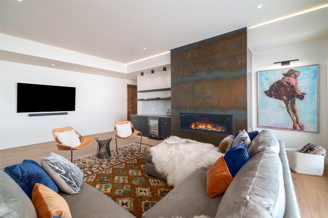 33200 Meadow Creek Dr, Steamboat Springs, CO 80487 - living area featuring wood finished floors, a fireplace, beverage cooler, and recessed lighting