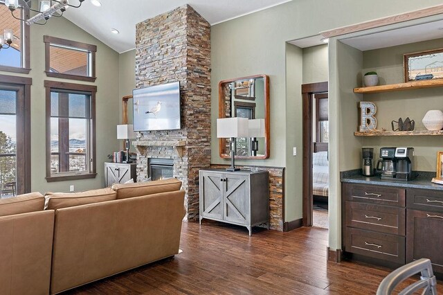 740 Cirrus Way, Granby, CO 80446 - living area with an inviting chandelier, a fireplace, dark wood-type flooring, and a healthy amount of sunlight