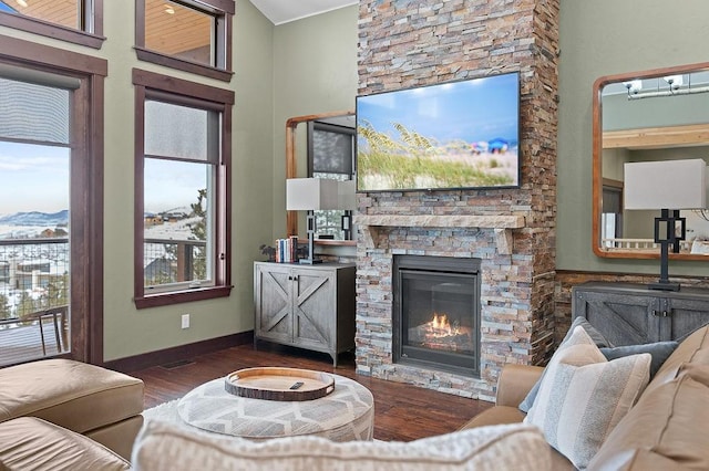740 Cirrus Way, Granby, CO 80446 - living area featuring baseboards, wood finished floors, a fireplace, and a healthy amount of sunlight
