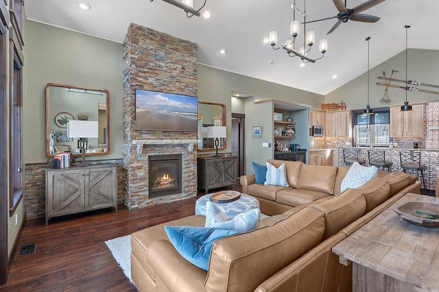 740 Cirrus Way, Granby, CO 80446 - living room with wood finished floors, visible vents, a fireplace, high vaulted ceiling, and ceiling fan with notable chandelier
