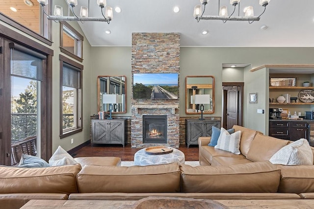 740 Cirrus Way, Granby, CO 80446 - living area featuring baseboards, wood finished floors, a fireplace, and a notable chandelier