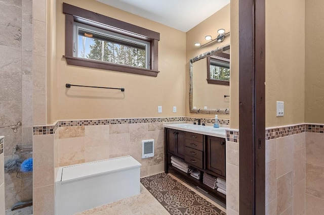 740 Cirrus Way, Granby, CO 80446 - full bathroom featuring a wainscoted wall, vanity, visible vents, and tile walls