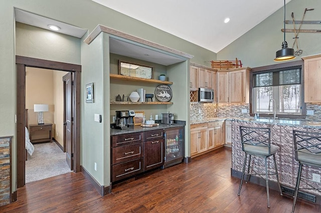 740 Cirrus Way, Granby, CO 80446 - kitchen with stainless steel microwave, light brown cabinets, dark wood-style floors, and wine cooler