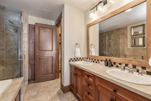 bathroom featuring visible vents, a sink, a shower stall, and double vanity