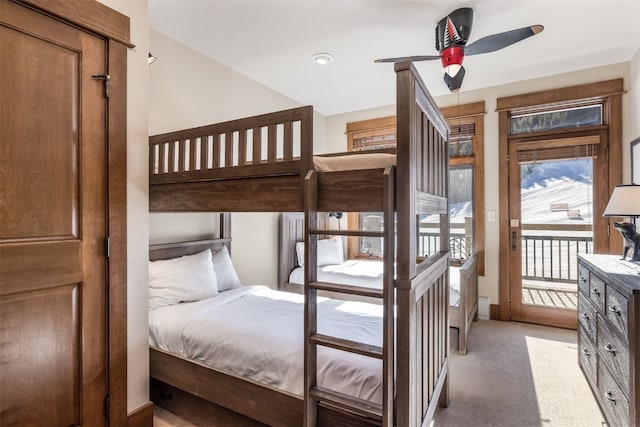 bedroom featuring light carpet, baseboards, and access to exterior