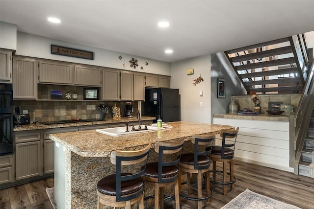 2315 Ski Trail Ln Unit 4, Steamboat Springs, CO 80487 - kitchen with black appliances, a sink, light countertops, dark wood-style floors, and decorative backsplash