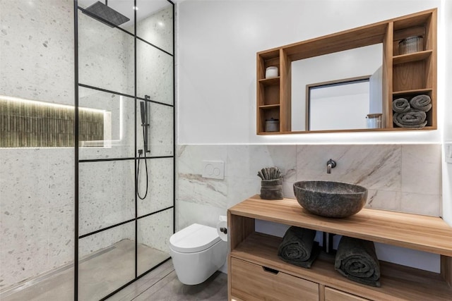 149 Game Trail Rd, Silverthorne, CO 80498 - bathroom featuring tile walls, walk in shower, a sink, and toilet