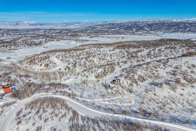 snowy aerial view with a mountain view