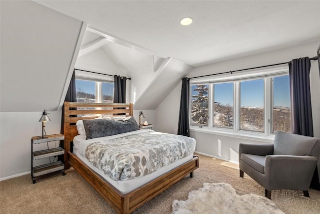 bedroom featuring light colored carpet, multiple windows, and lofted ceiling