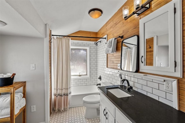 full bathroom featuring toilet, vanity, shower / bath combination with curtain, and lofted ceiling