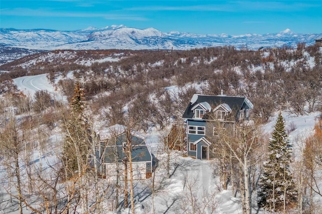 snowy aerial view with a mountain view