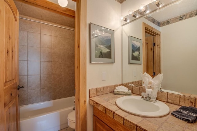 bathroom featuring toilet, vanity, and shower / tub combination