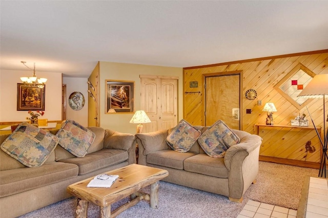 living area featuring light colored carpet, a notable chandelier, light tile patterned flooring, and wooden walls