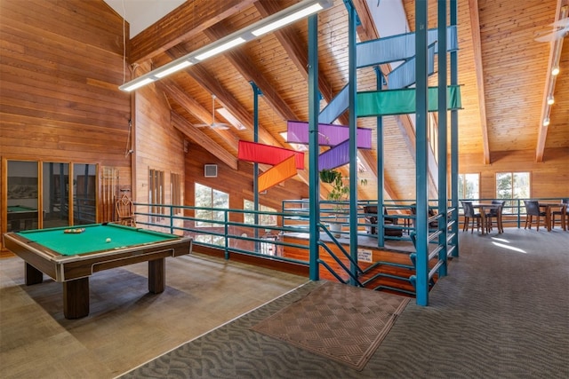 recreation room featuring wood walls, wood ceiling, high vaulted ceiling, and carpet