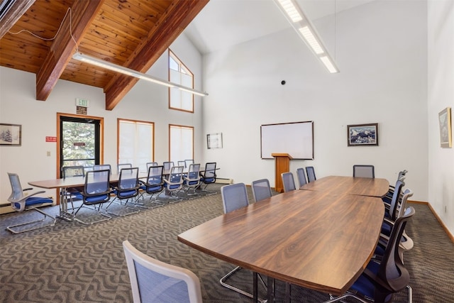 dining area with carpet flooring, high vaulted ceiling, baseboards, and beamed ceiling