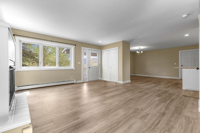 485 Amethyst Dr, Steamboat Springs, CO 80487 - unfurnished living room with baseboard heating, a chandelier, light wood finished floors, baseboards, and recessed lighting