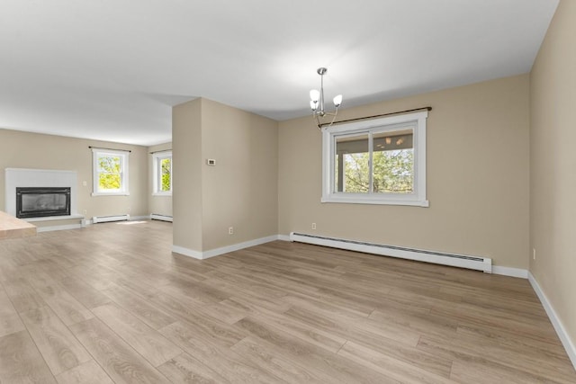 485 Amethyst Dr, Steamboat Springs, CO 80487 - unfurnished living room featuring baseboard heating, a baseboard radiator, light wood-style flooring, and baseboards