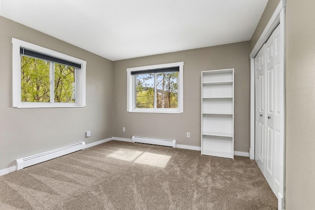 485 Amethyst Dr, Steamboat Springs, CO 80487 - unfurnished bedroom with baseboard heating, carpet, baseboards, and a closet