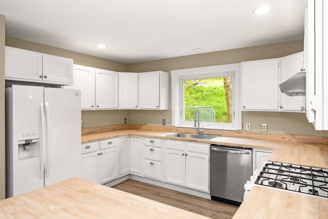 485 Amethyst Dr, Steamboat Springs, CO 80487 - kitchen featuring white refrigerator with ice dispenser, dishwasher, a sink, under cabinet range hood, and butcher block counters