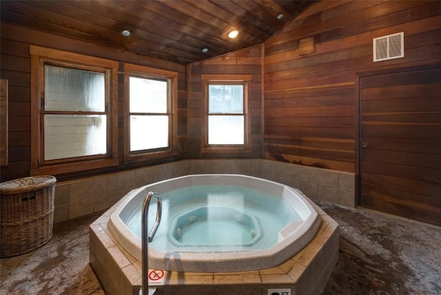 2700 Village Dr Unit B102, Steamboat Springs, CO 80487 - bathroom featuring vaulted ceiling, wooden ceiling, a tub with jets, and wooden walls