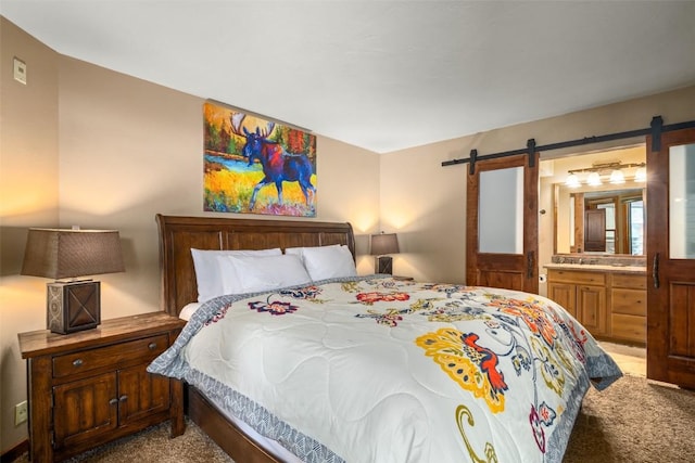 2700 Village Dr Unit B102, Steamboat Springs, CO 80487 - carpeted bedroom featuring a barn door and connected bathroom