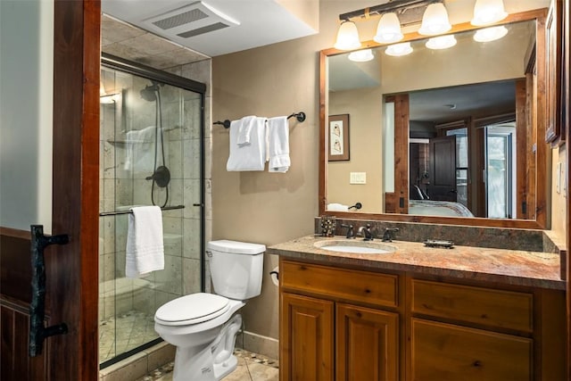 2700 Village Dr Unit B102, Steamboat Springs, CO 80487 - bathroom featuring a stall shower, vanity, toilet, ensuite bath, and tile patterned floors