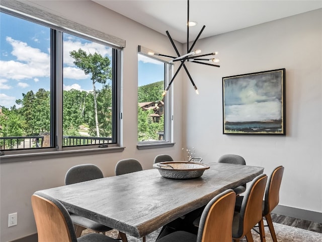 184 Caravelle Dr Unit 20, Keystone, CO 80435 - dining area featuring healthy amount of natural light, a chandelier, and wood finished floors