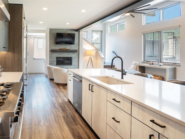 184 Caravelle Dr Unit 20, Keystone, CO 80435 - kitchen featuring open floor plan, light countertops, ceiling fan, a large fireplace, and dark wood-style flooring