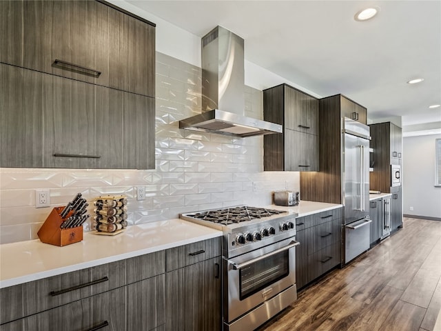 184 Caravelle Dr Unit 20, Keystone, CO 80435 - kitchen featuring high quality appliances, wall chimney range hood, modern cabinets, wood finished floors, and recessed lighting